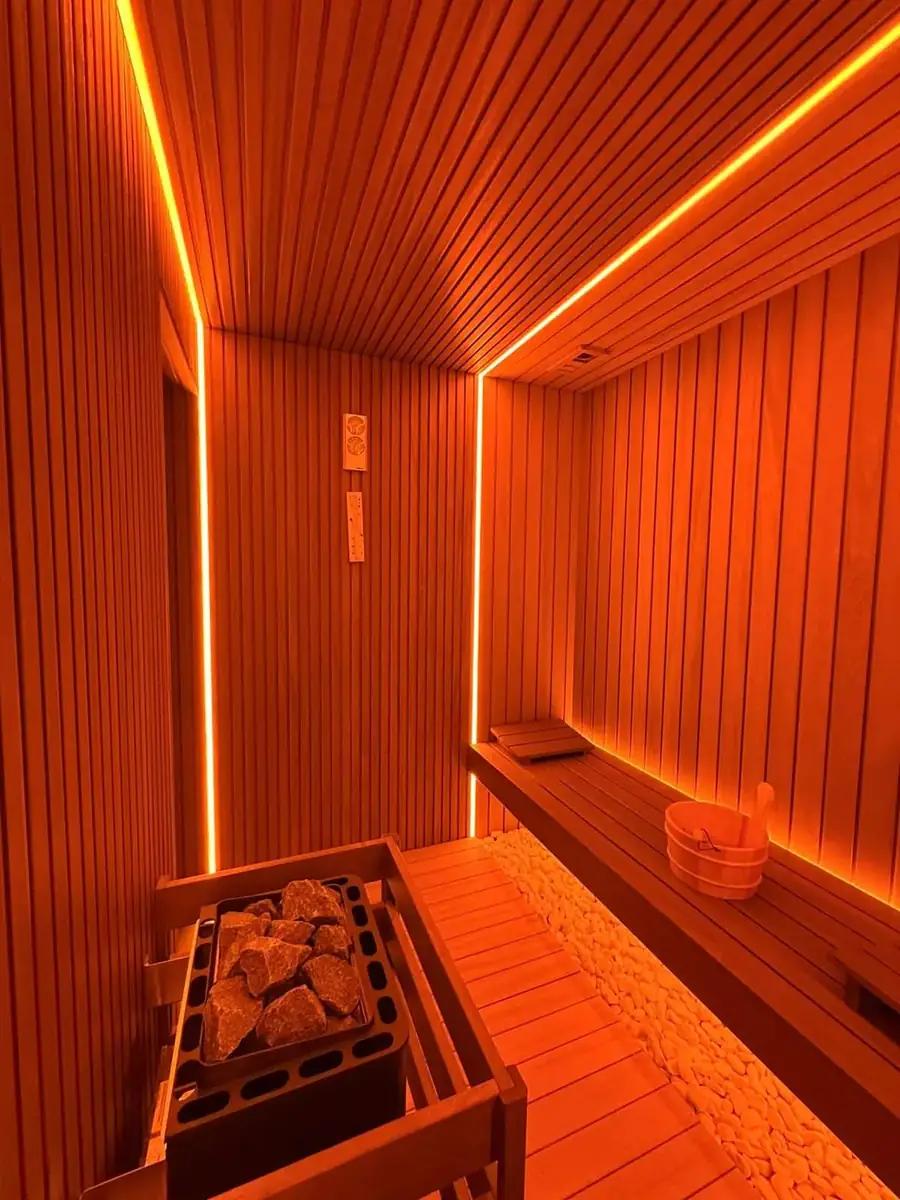 Sauna Dekor branded backrest and white pebble bed in a private villa sauna
