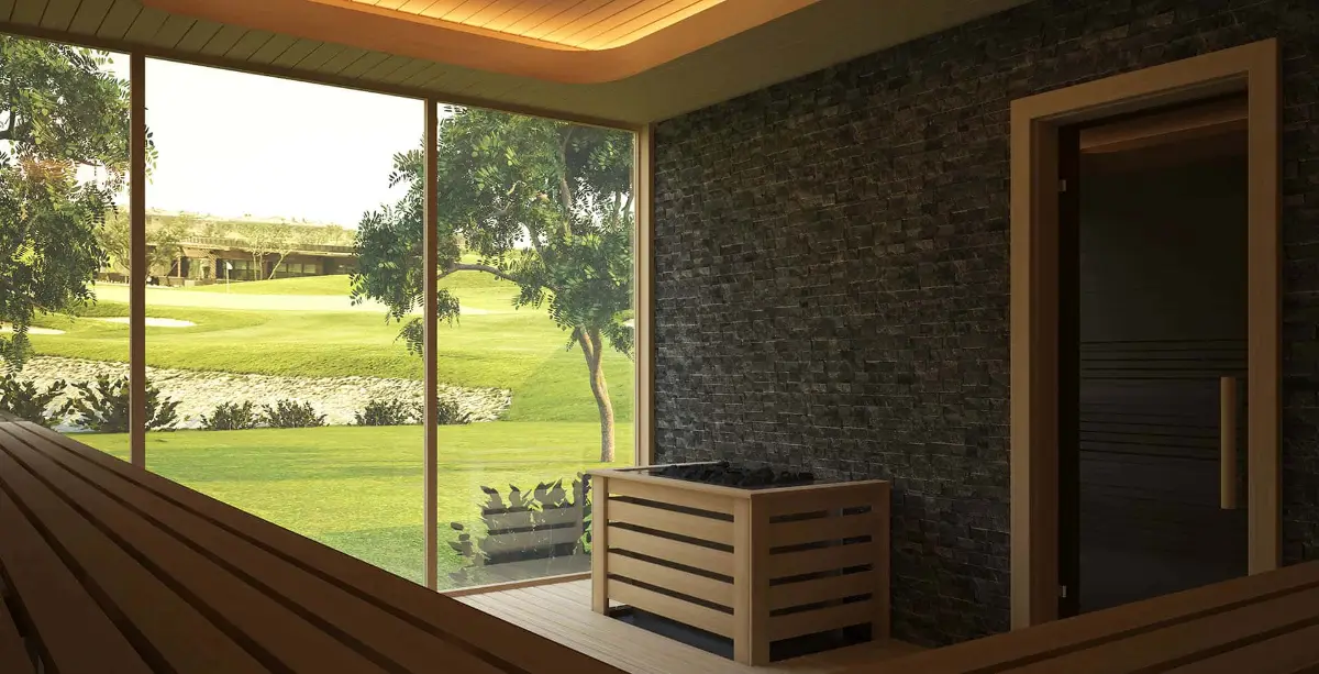 Sauna with full-height glazing onto a golf course, a slatted heater guard and a split-stone wall