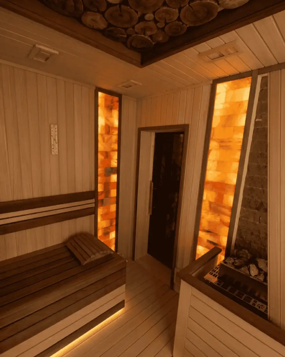 Private villa sauna with backlit Himalayan salt panels and a log-slice ceiling