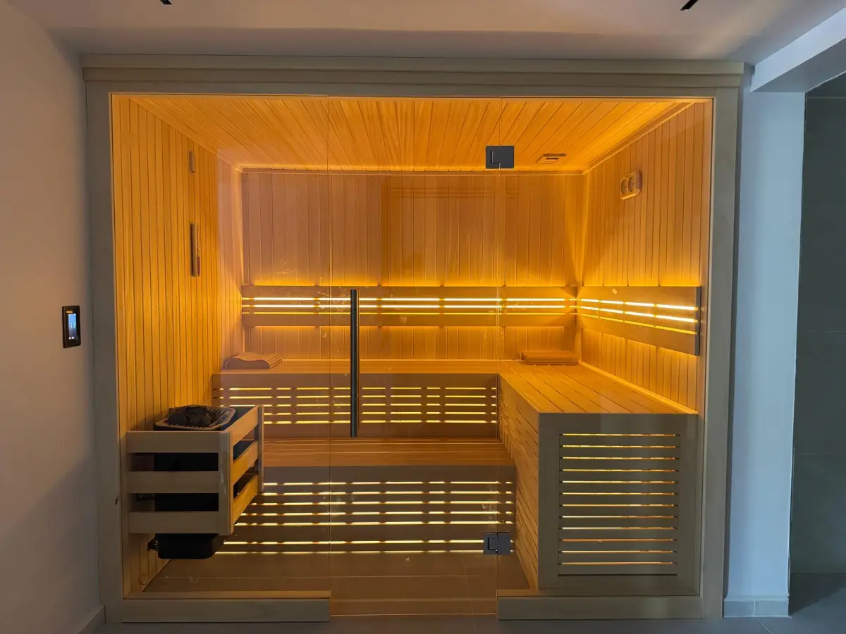 Lusail villa Finnish sauna with LED-lit benches, a glass front and a corner heater