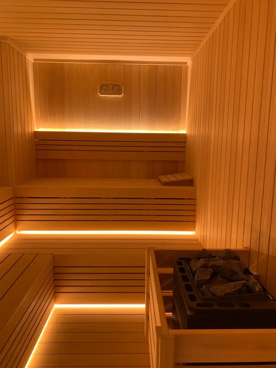 The Pearl Qatar villa sauna with a stone heater, headrest and LED-lit benches